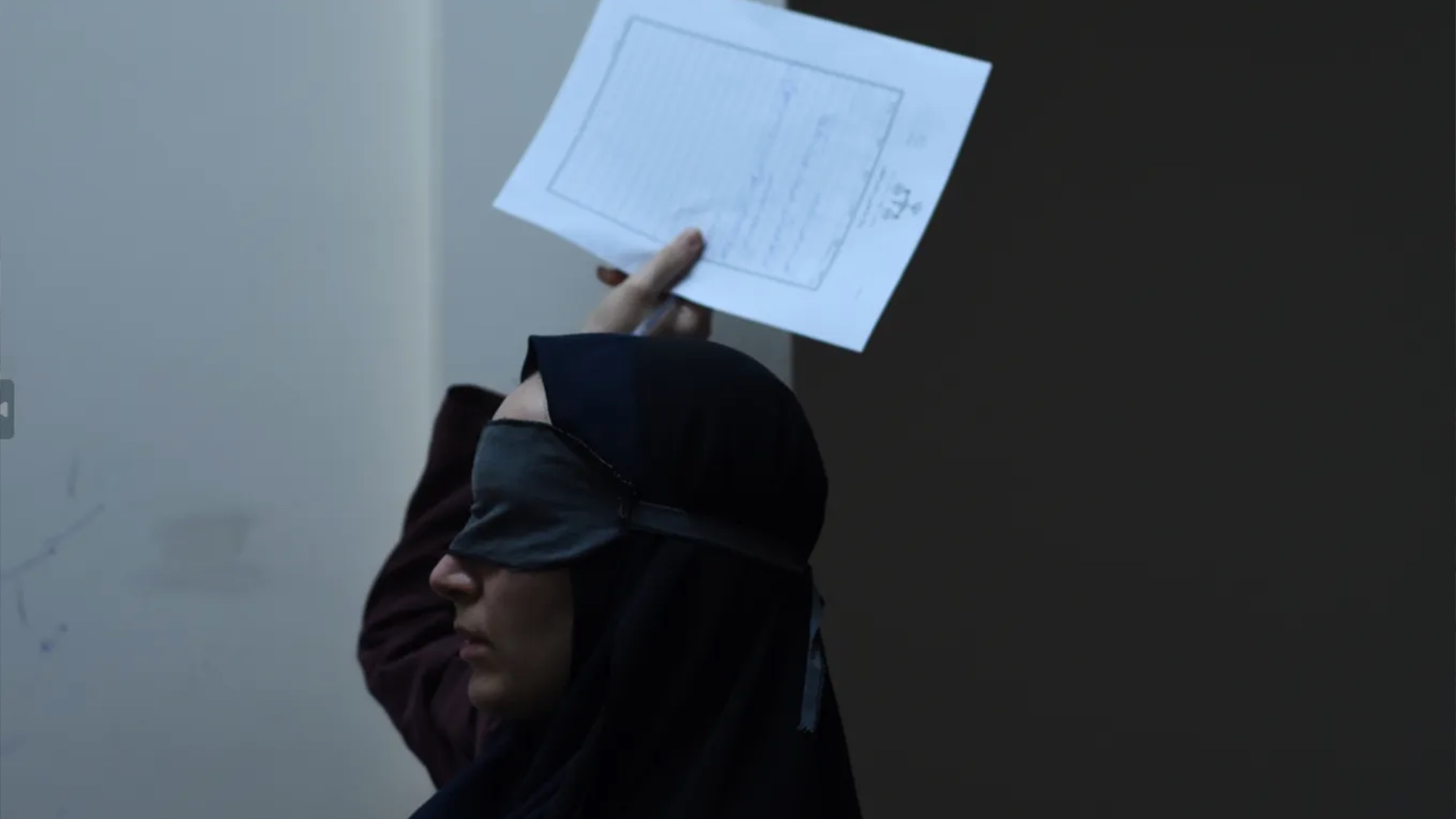 Woman blindfolded handing back a paper