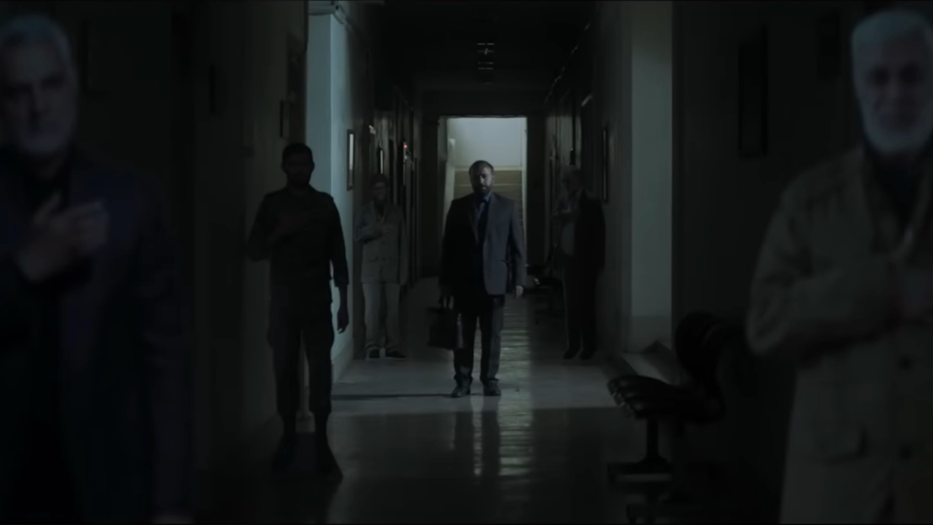 Man standing in dark hall