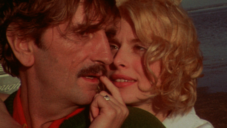 Travis (Harry Dean Stanton) embraced from behind by his blonde missing wife (Nastassja KInski)
