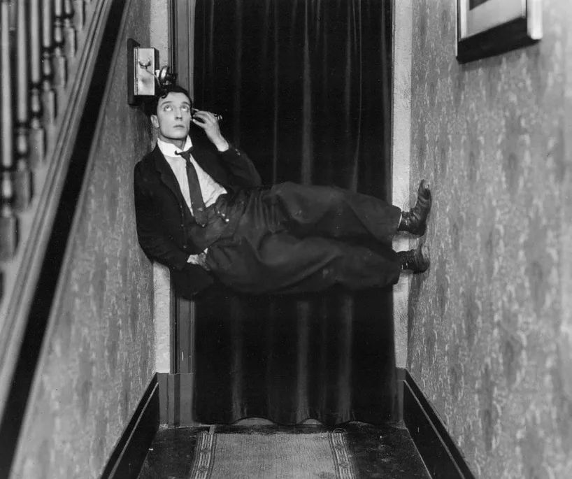 Buster Keaton speaking on the phone in the hallway and defying gravity