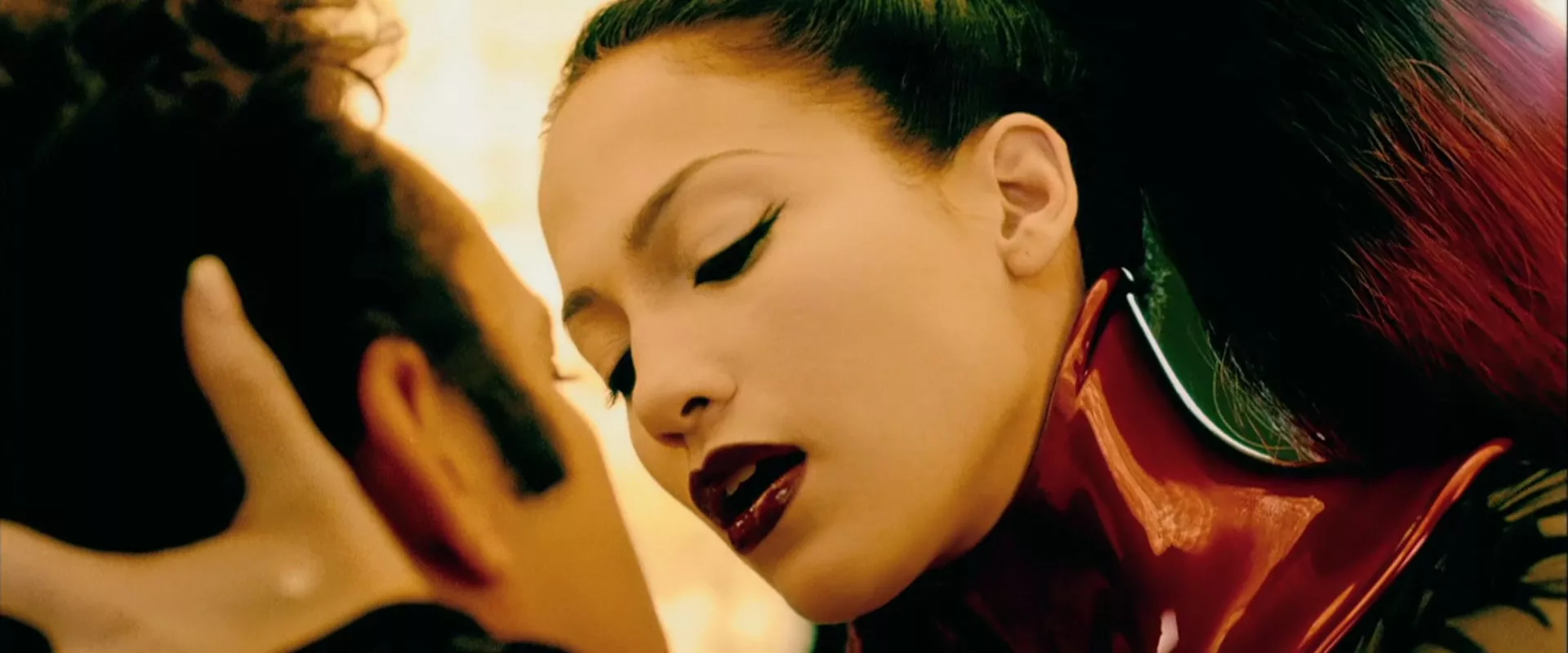 Jennifer Lopez as cyberpunk sphinx going for a kiss with a man