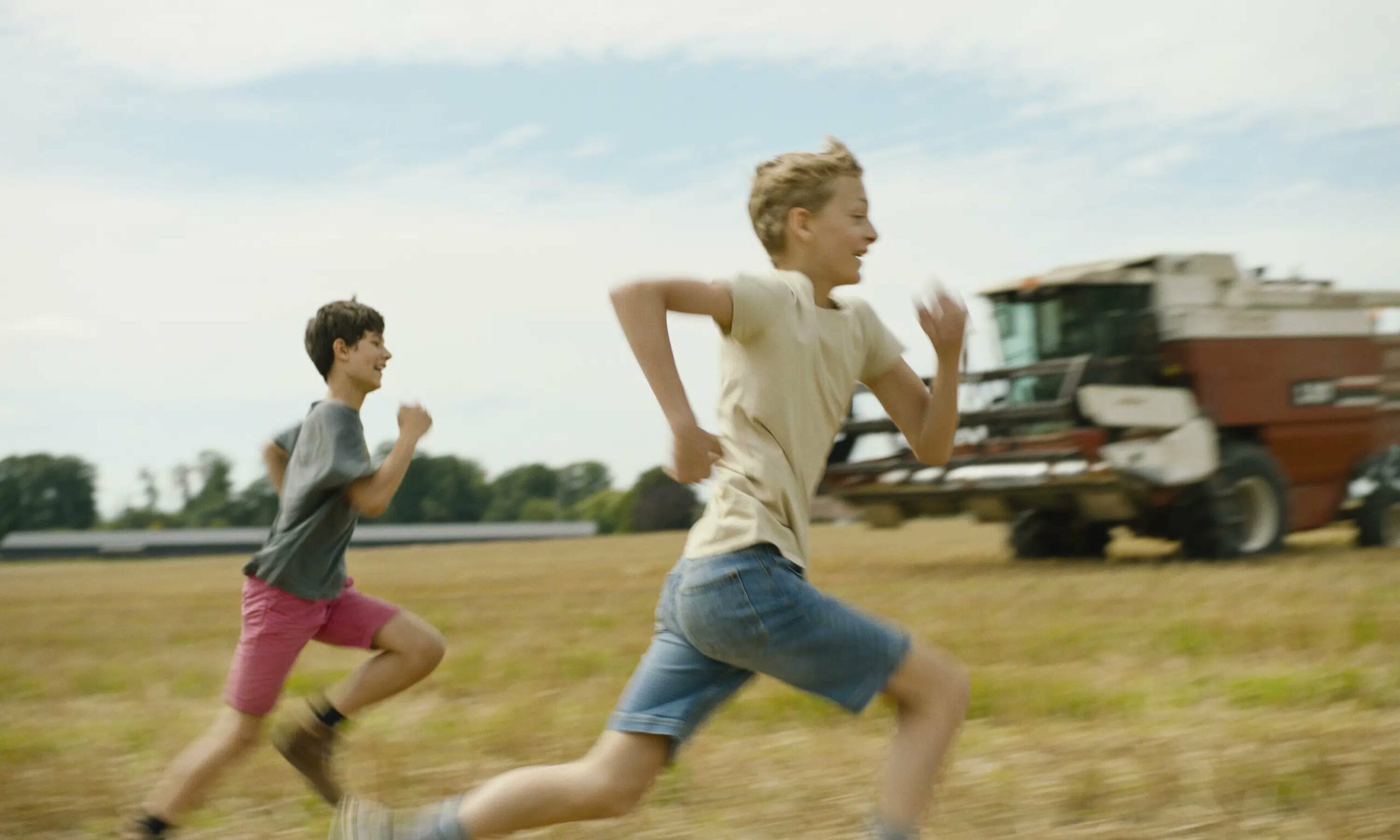 Leo and Remi, two thirteen-year-old best friends, running in the field in Close, an Oscar 2023 nominated international feature film