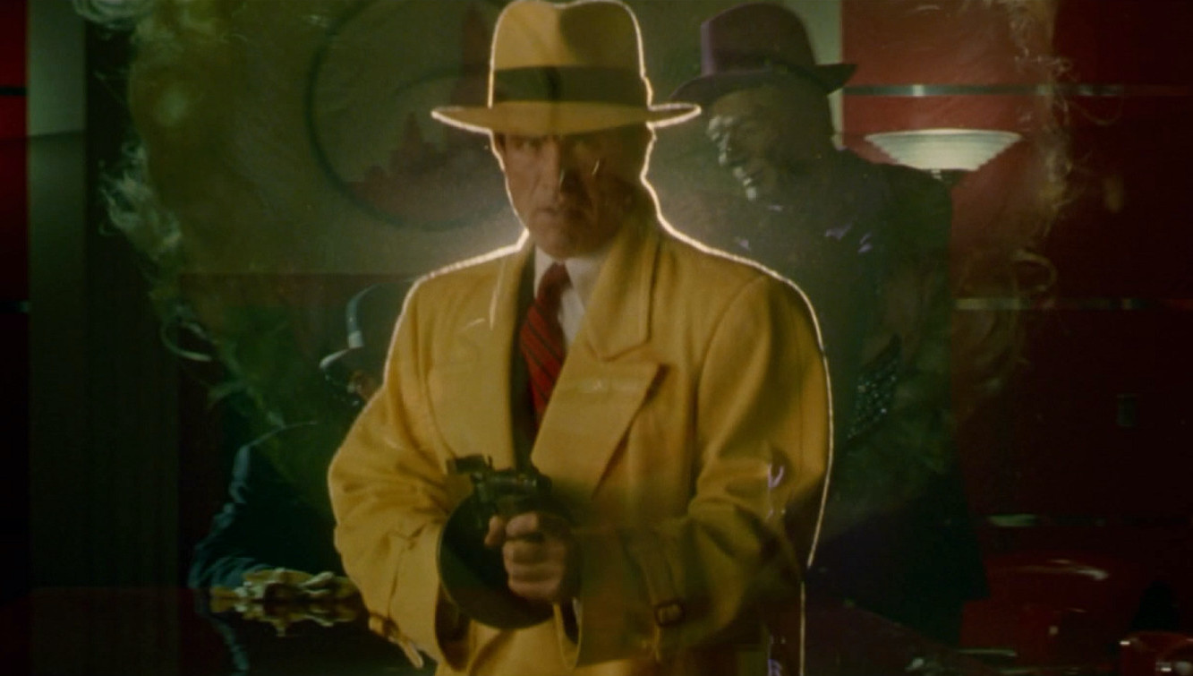 A scary-looking man in a hat, backlit with harsh yellow light, pointing a rifle past the camera
