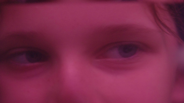 Close-up of a young woman's face in pink
