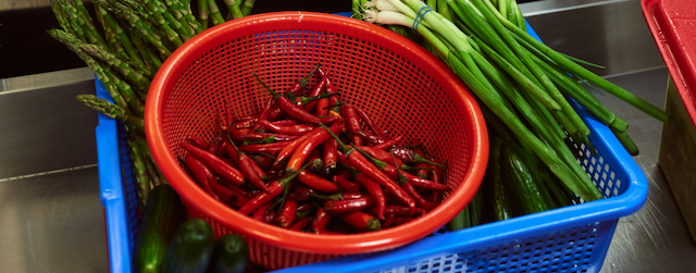 Red peppers in a red basket