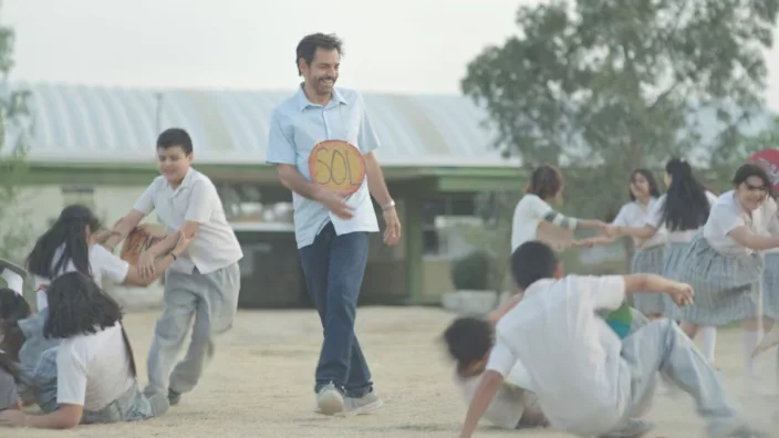 MVFF46: Radical - A man smiles while looking at a group of children playing.