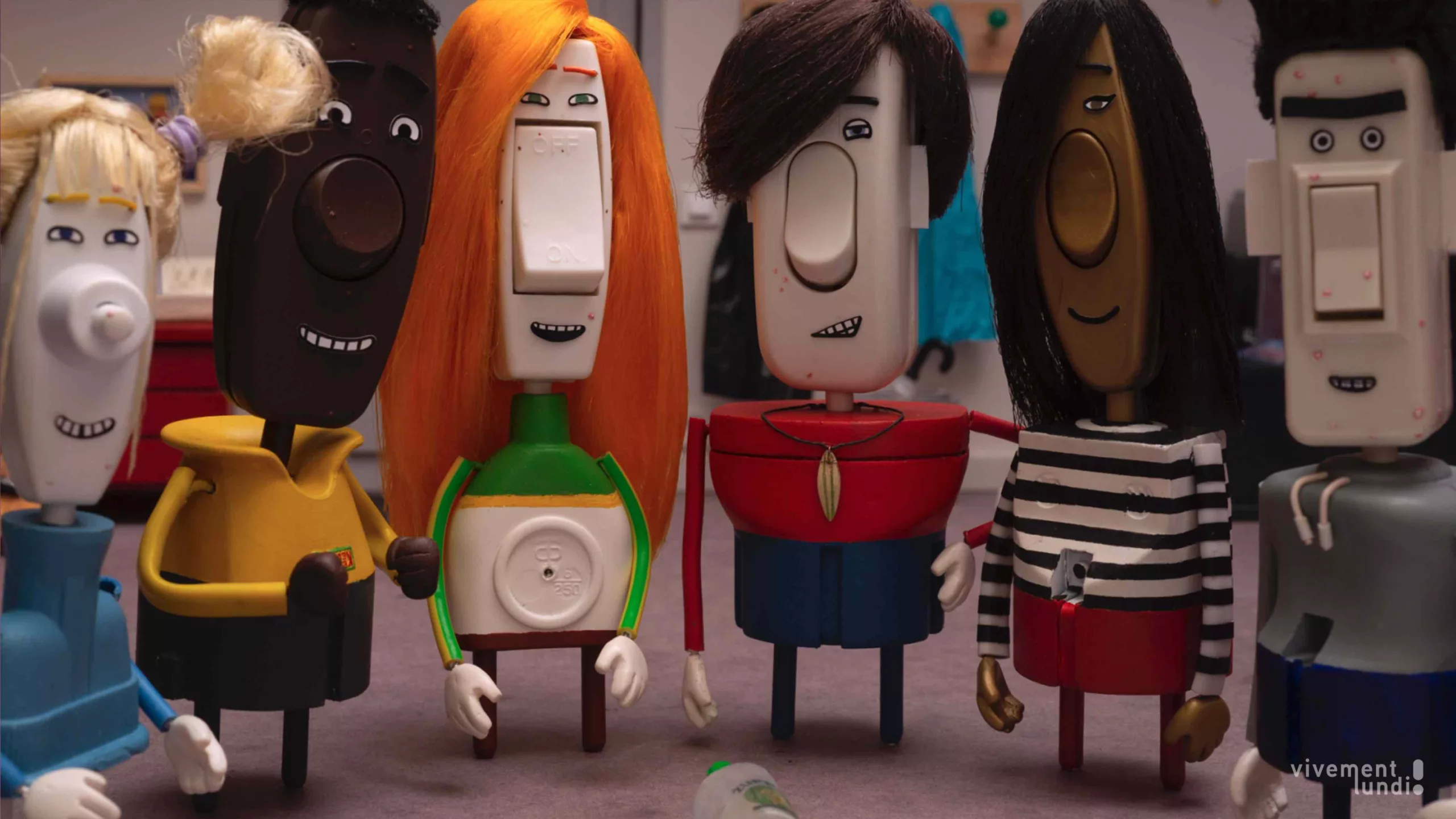 Five sculpted characters stand in a semi circle.