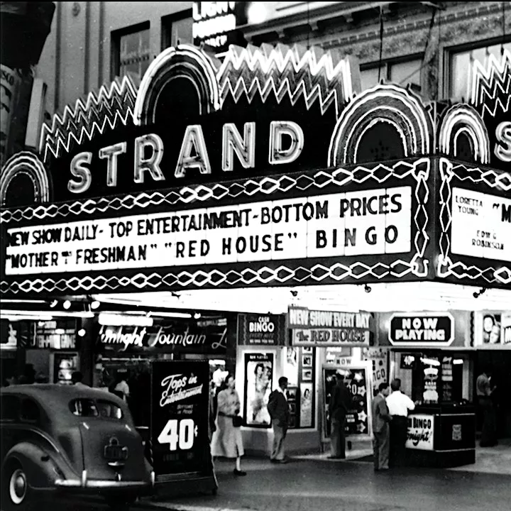 Black and white photo of STRAND theater movie marquee