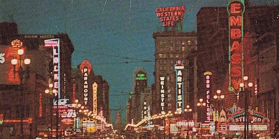 Image of market street in San Francisco glowing with neon signs at twilight.