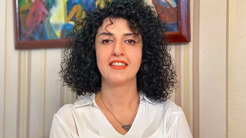 a woman with curly black hair - Iranian activist Narges Mahammadi