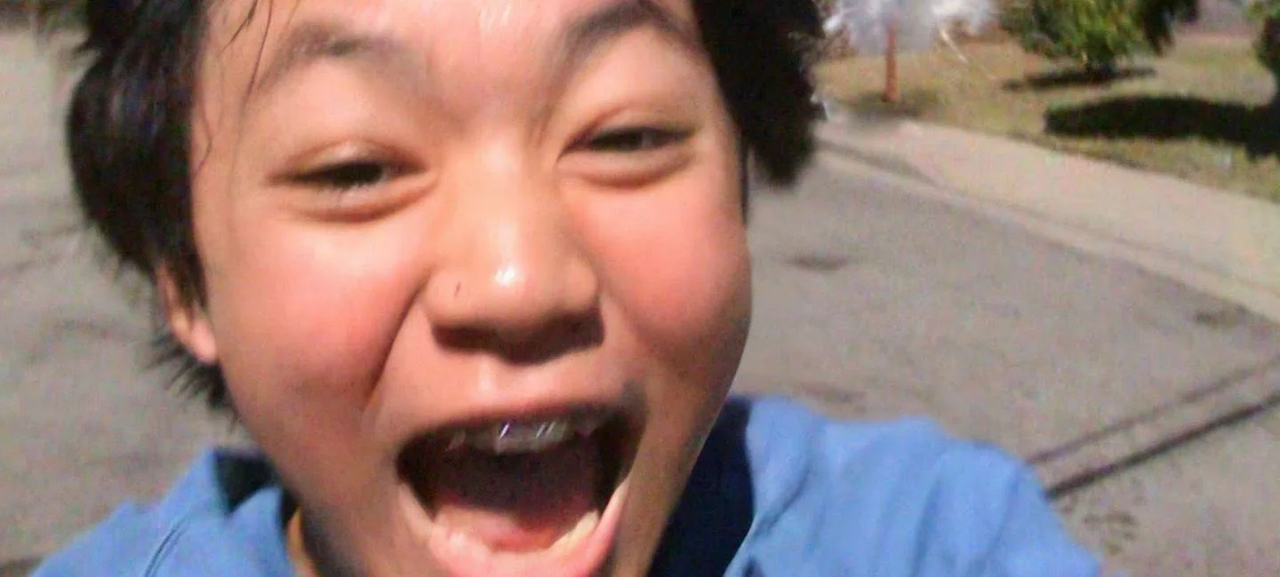 A young Asian boy with an excited expression on his face