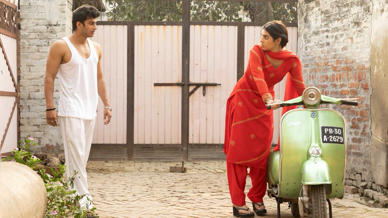 man in white approaches woman in red