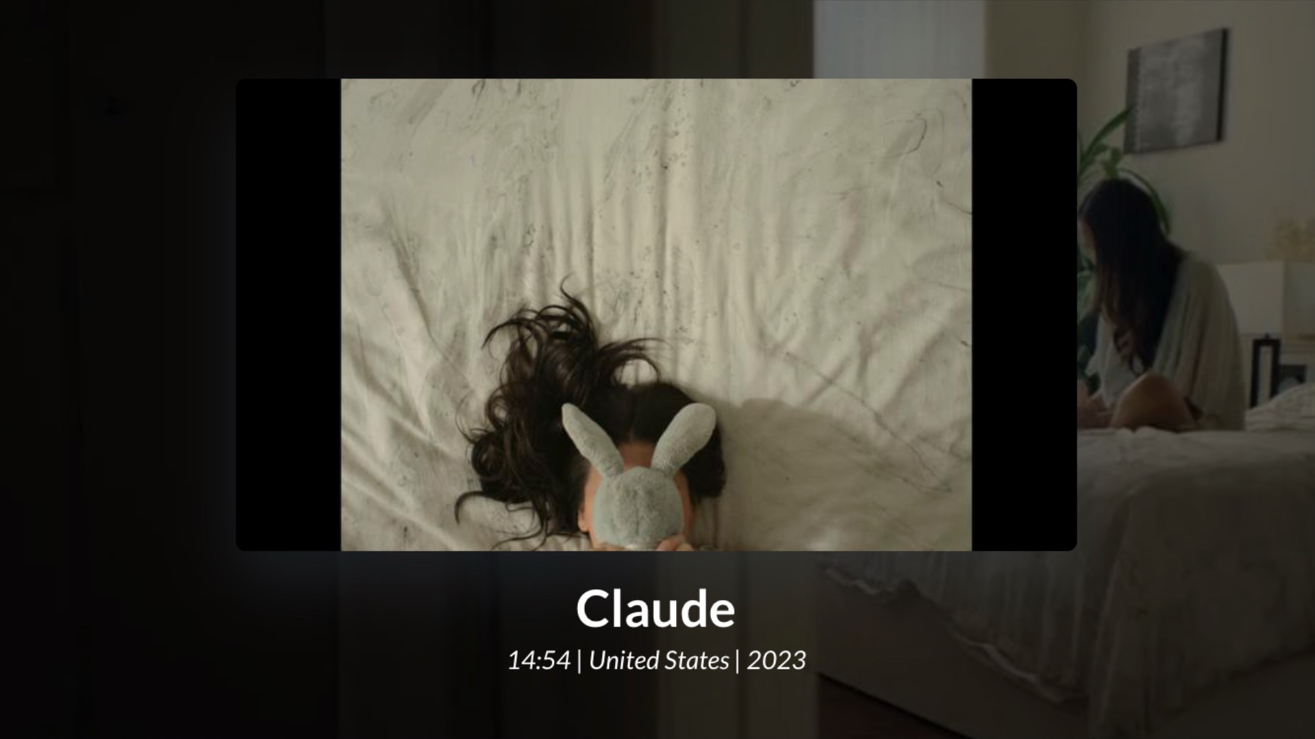 person in bed covering their face with stuffed animal