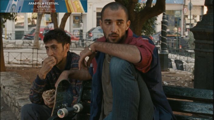 Two men sitting in the streets of Greece