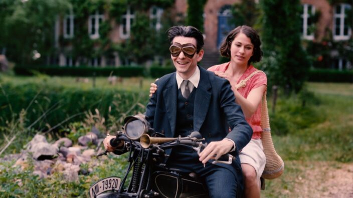 man and woman riding away on motorcycle