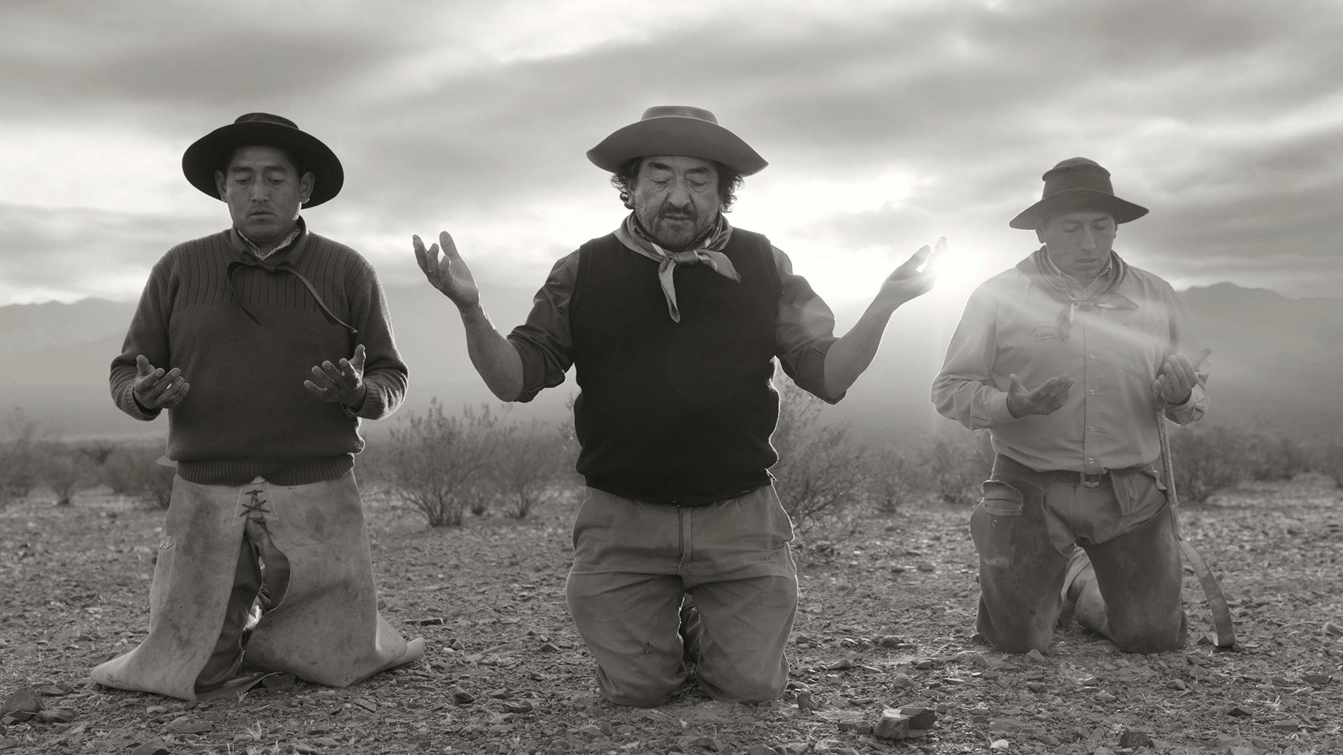 Three man on their knees praying
