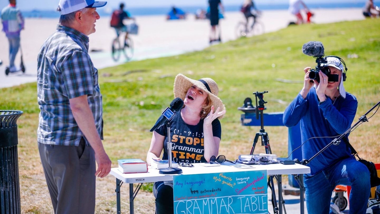 woman behind a table out of doors
