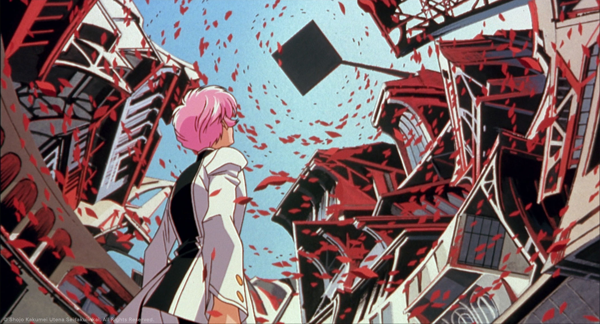 A figure looks towards the sky and building above as petals swirl through the air